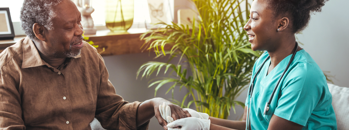 Nurse with Senior Patient Closeup of a support hands. Closeup shot of a young woman holding a senior man's hands in comfort. Female carer holding hands of senior man