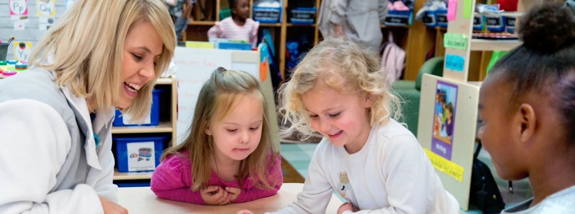 A teacher with a group of pre-k students
