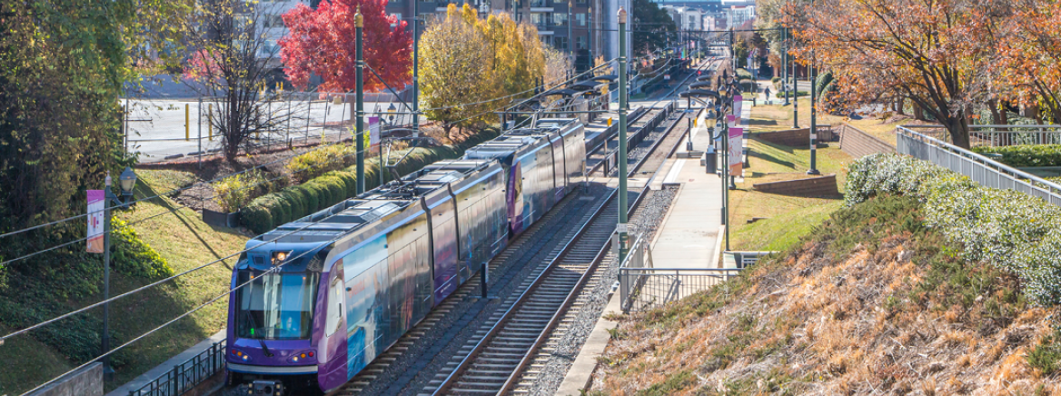 The light rail moving  through a newly redeveloped community.