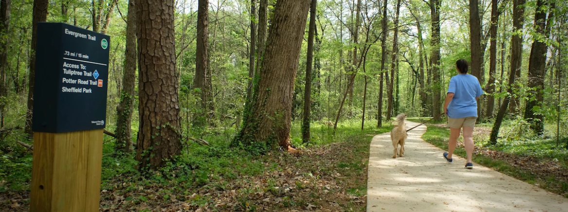 mc-img-parks-nature-preserve Lady with dog walking a nature trail