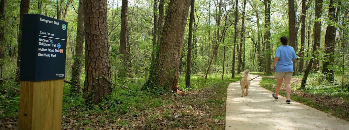 Lady with dog walking a nature trail