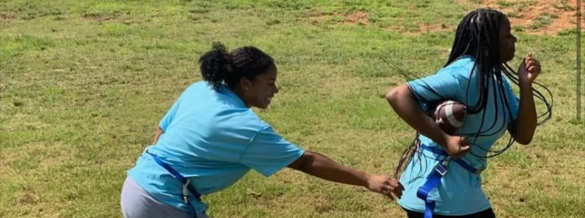 Girls play flag football