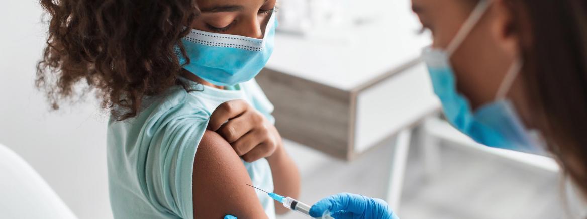 Children Vaccination. Preteen Black Girl Getting Vaccinated For Covid-19 Prevention Sitting In Clinic. Medical Worker Wearing Face Mask Injecting Kid Patient. Antiviral Immunization. Cropped