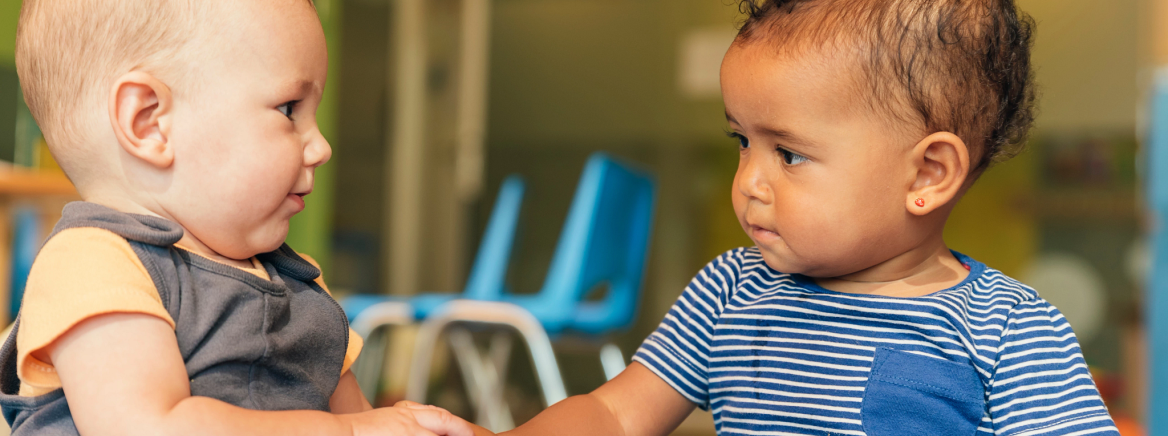 Header - Daycare Kids Two babies interacting at daycare