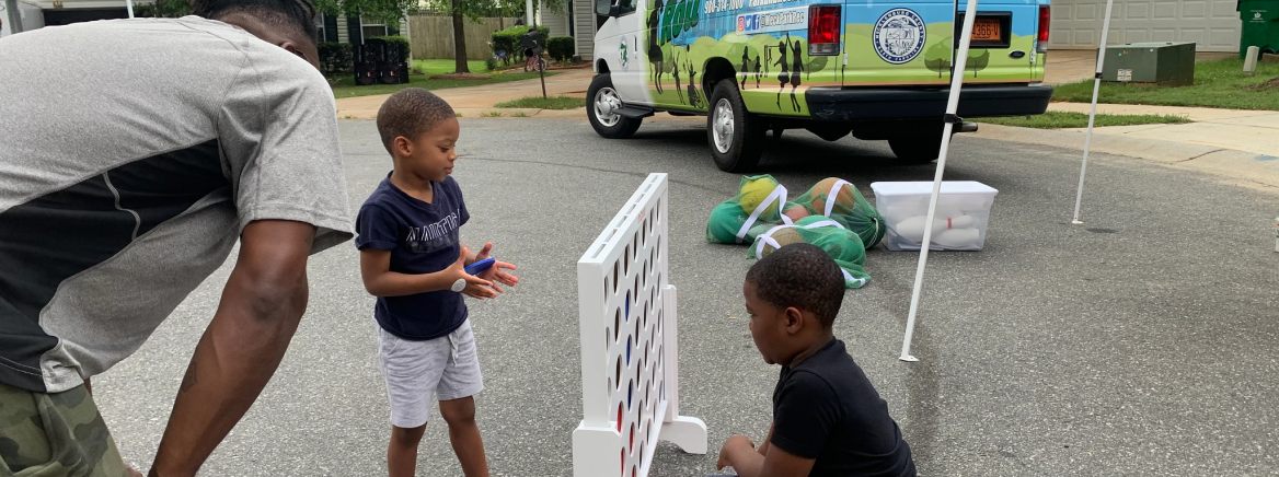 Children playing in the street at an event.