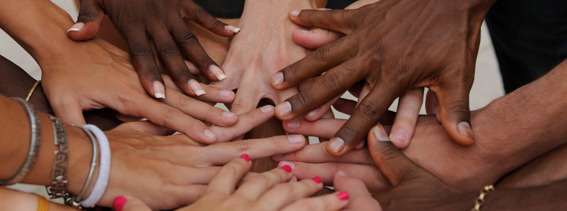 Many hands together: group of diverse people joining hands