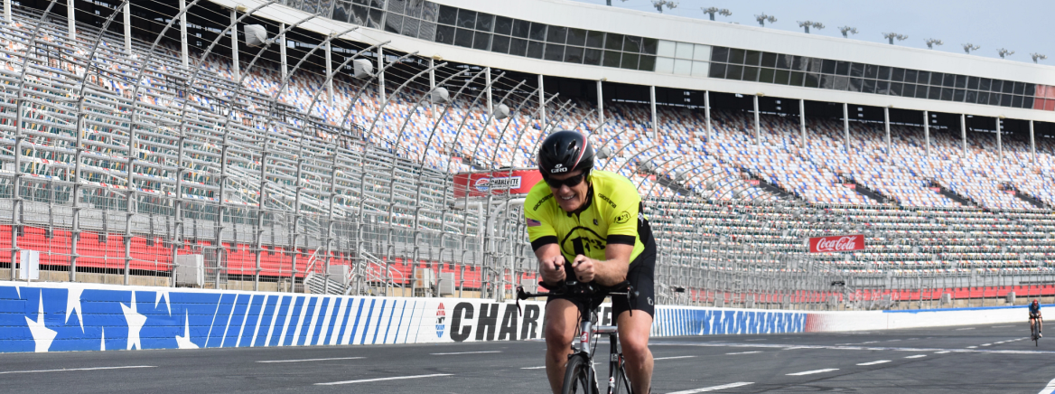 A cyclist riding on the track at the Charlotte Motor Speedway.