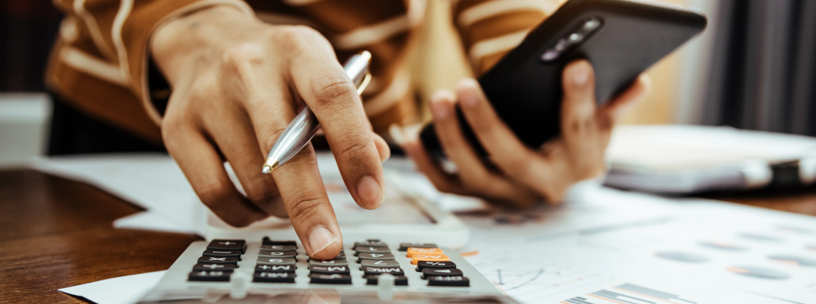 images of a person balancing a budget with a calculator.