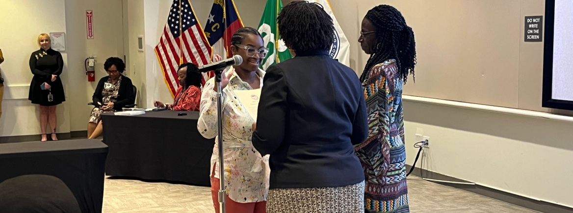 Deputy Clerk Sworn In Arlissa Eason was sworn in before a full meeting of County Commissioners on March 25, 2025. Her supervisor, Kristine Smith, Clerk to the Board, administered the oath. With right hand raised and left hand on a Bible held by her mother, Eason recited the oath that is required for her to perform all necessary duties in case the Clerk to the Board is unable to attend a meeting of the Board of County Commissioners.