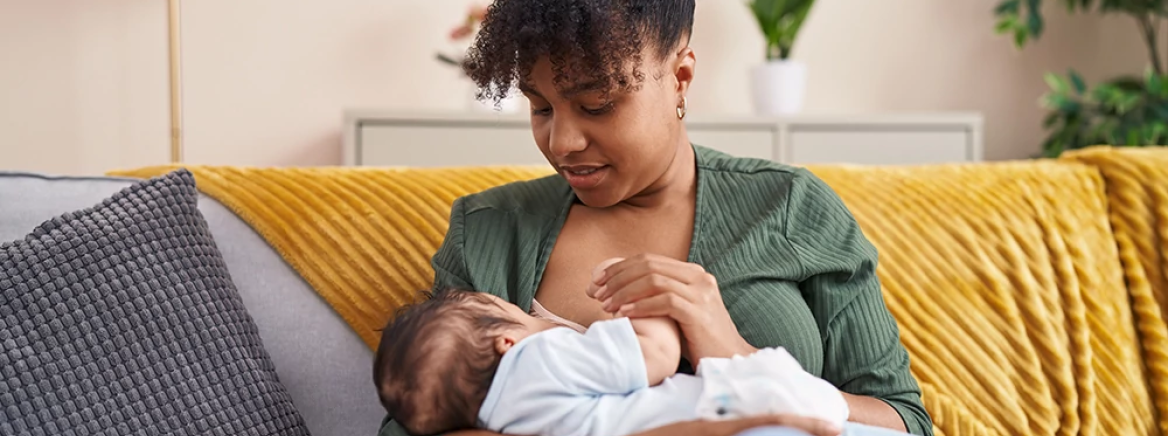 Mother and son sitting on sofa breastfeeding at home Mother and son sitting on sofa breastfeeding at home