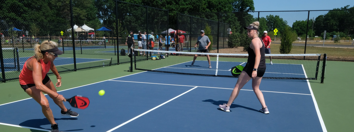 Pickleball An adult moves to the edge of the court to hit the pickleball as three other players watch.
Opening of Clarks Creek Park on Hucks Road