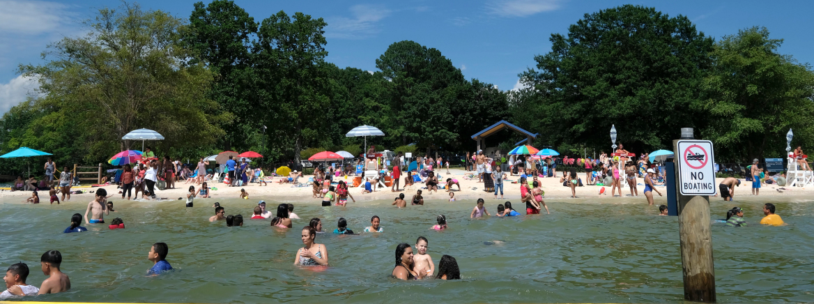 Familes enjoying summer at Ramsey Creek Beach in Cornelius.