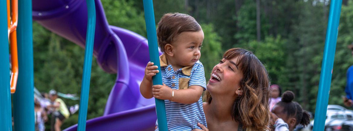 Mallard Creek Recreation Center community celebration A smiling mom and child on a playground at the Mallard Creek Recreation Center Community Celebration for reopening after renovations. May 03, 2025.