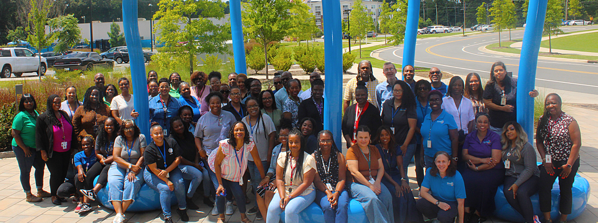 Child Support Staff Child Support Staff posing outside an art installation at Valerie C. Woodard Center.