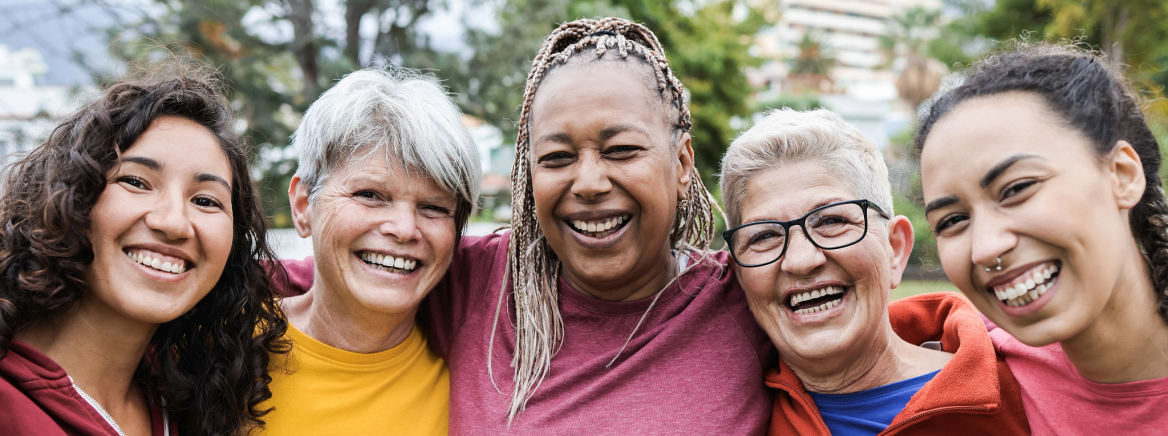 Happy multi generational women having fun together - Multiracial friends smiling on camera after sport workout outdoor - Main focus on african female face