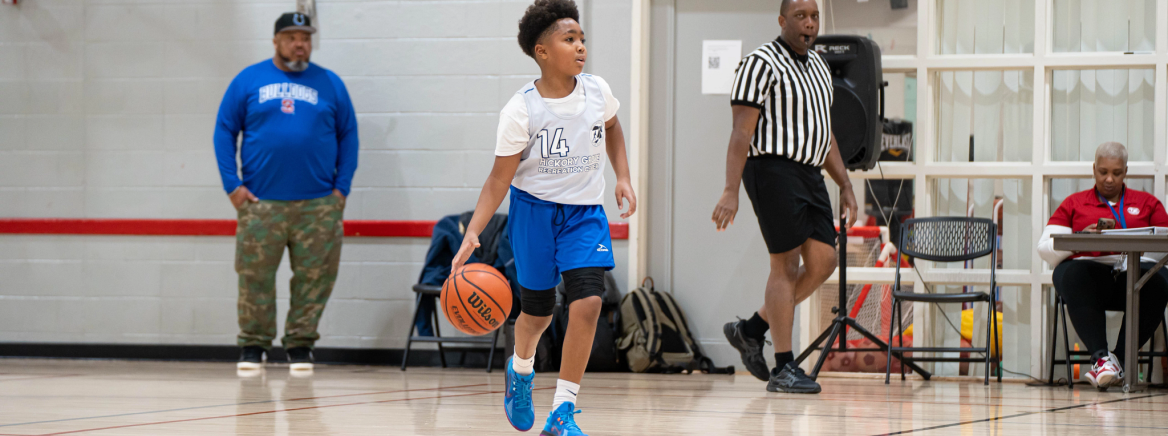 Child playing basketball at Tuckaseegee Region Recreation Center.