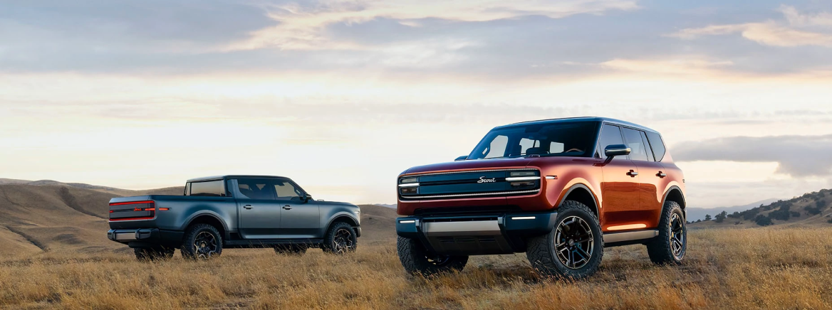 Two vehicles parked in a field.