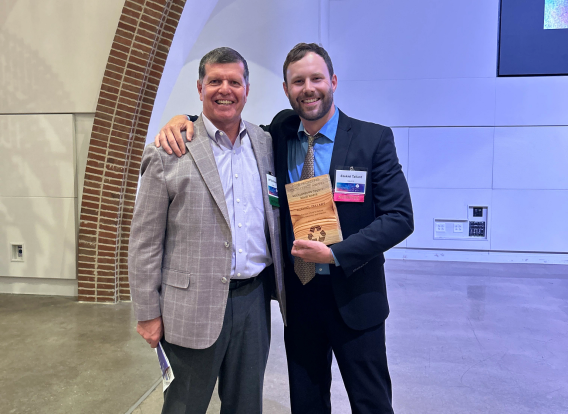 Solid Waste Director Jeff Smithberger stands with the recipient of Sustain Charlotte&#039;s Recycling Excellence award, Ezekiel “Zeke” Tallant.