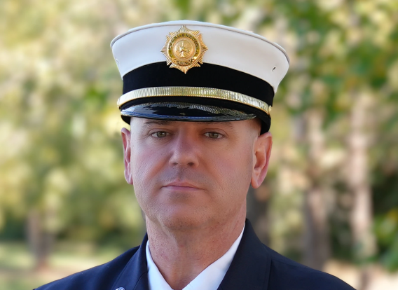 Headshot of Matthew Bixler, County Fire Marshal. Bixler is dressed in a uniform and standing outside.