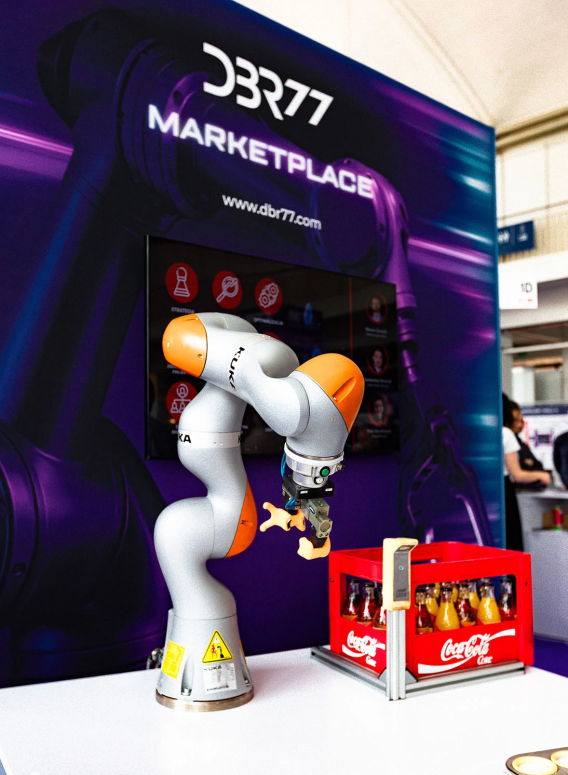 A robot in front of a banner that says DBR77b Marketplace